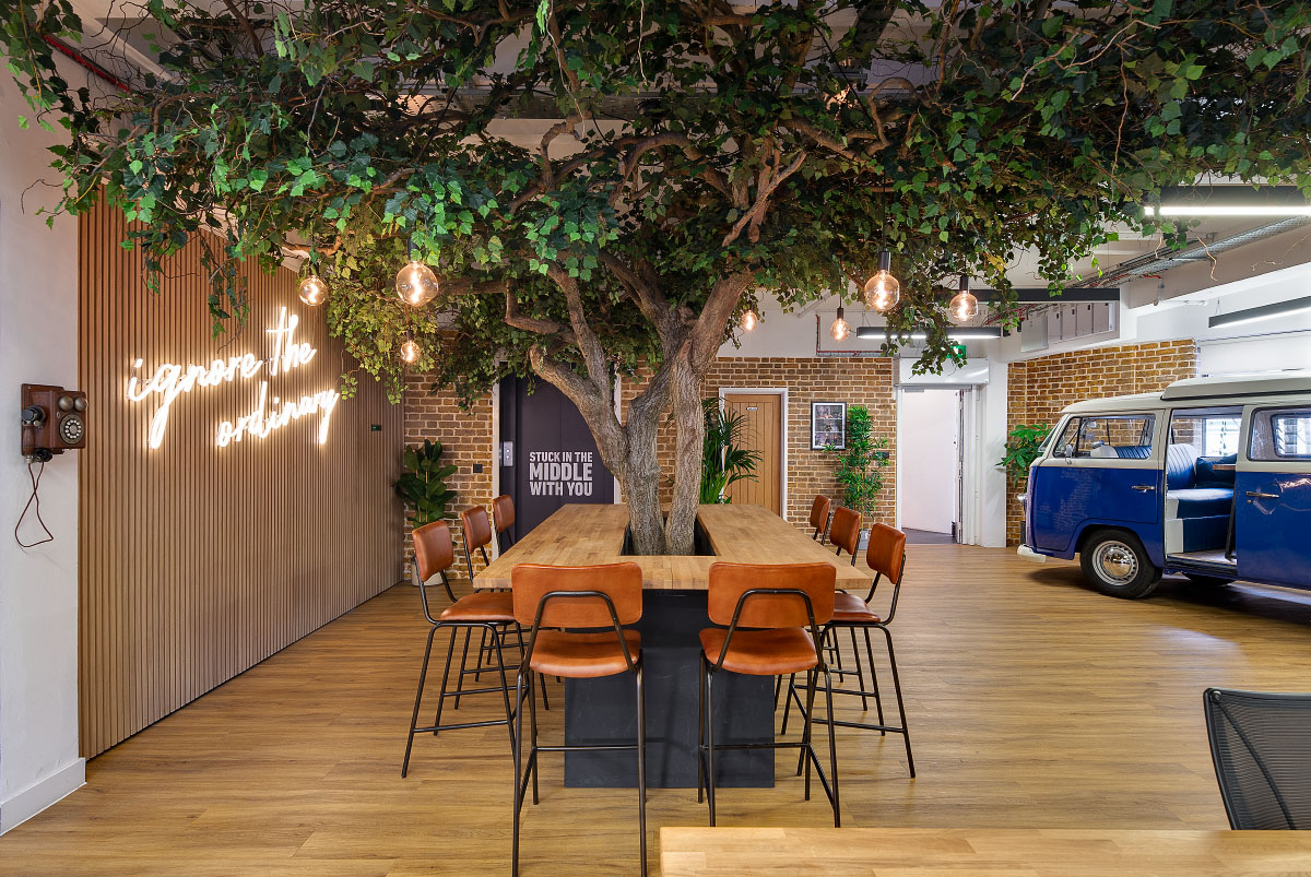 Wiser collaborative hub featuring a large tree with hanging lights and a LED sign displaying 