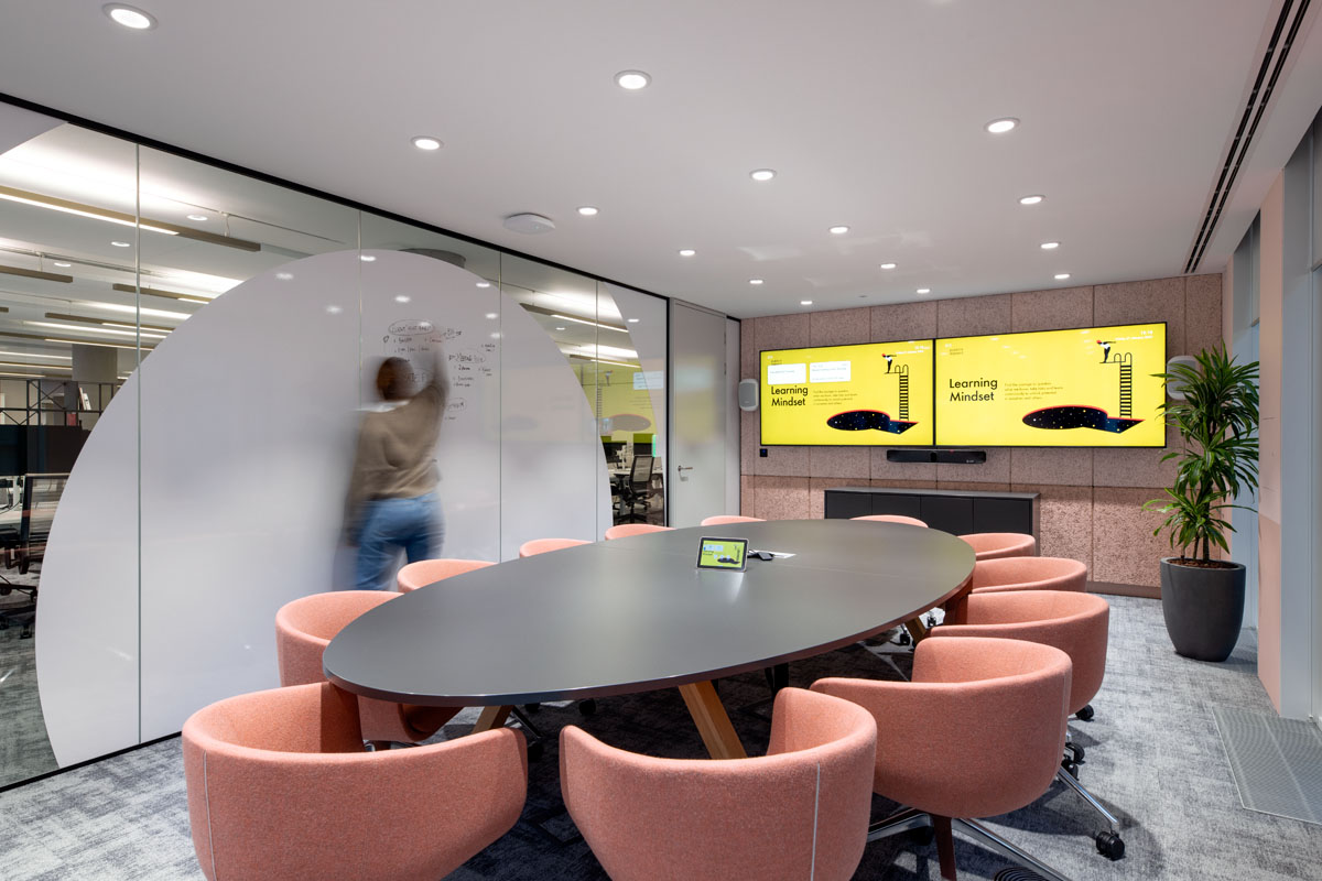 Modern meeting room at Publicis Sapient’s office with digital screens, whiteboards and writable walls.