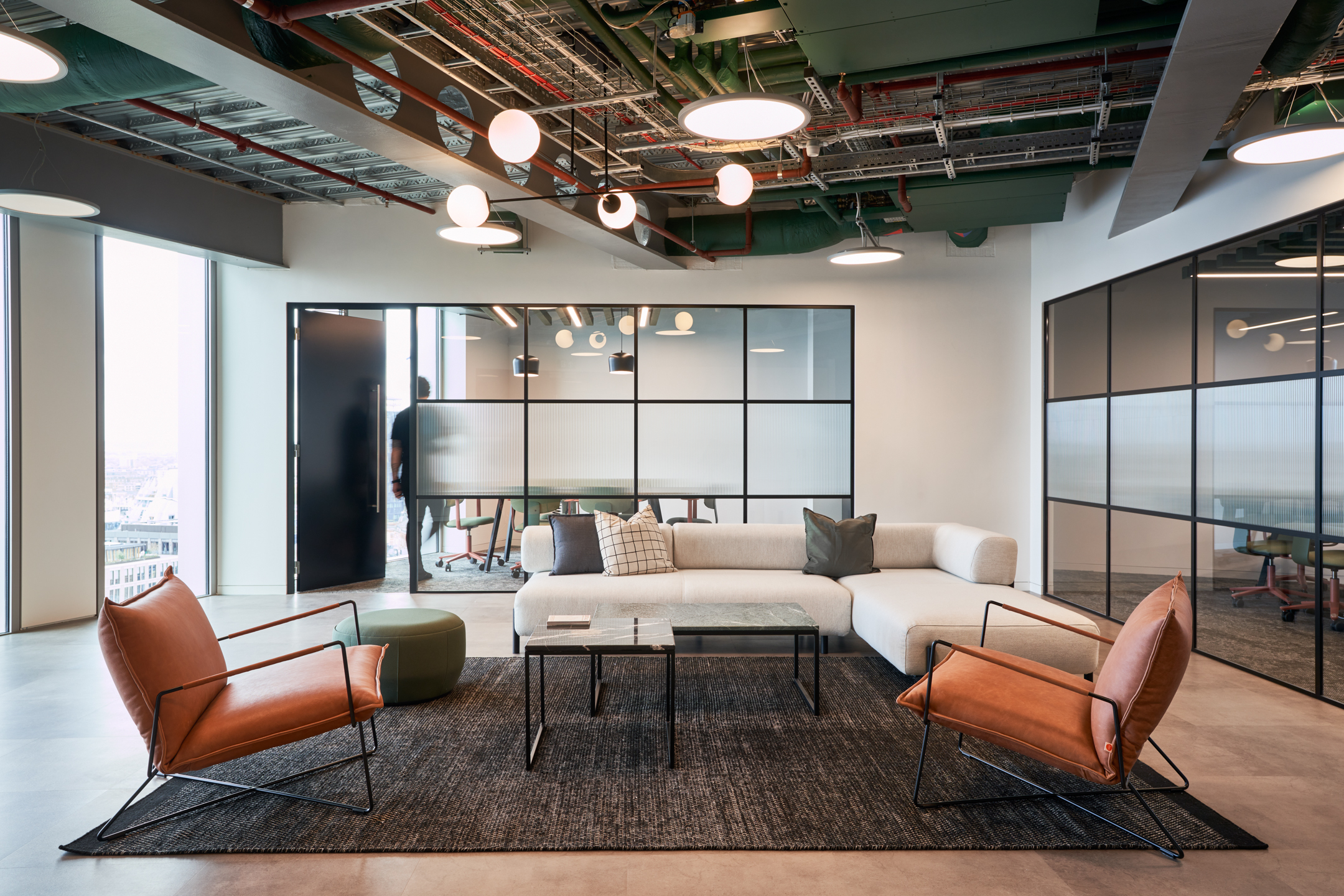 Modern lounge area in HYLO’s office with comfortable seating and large windows. The space is designed for informal meetings and relaxation, enhancing employee comfort.