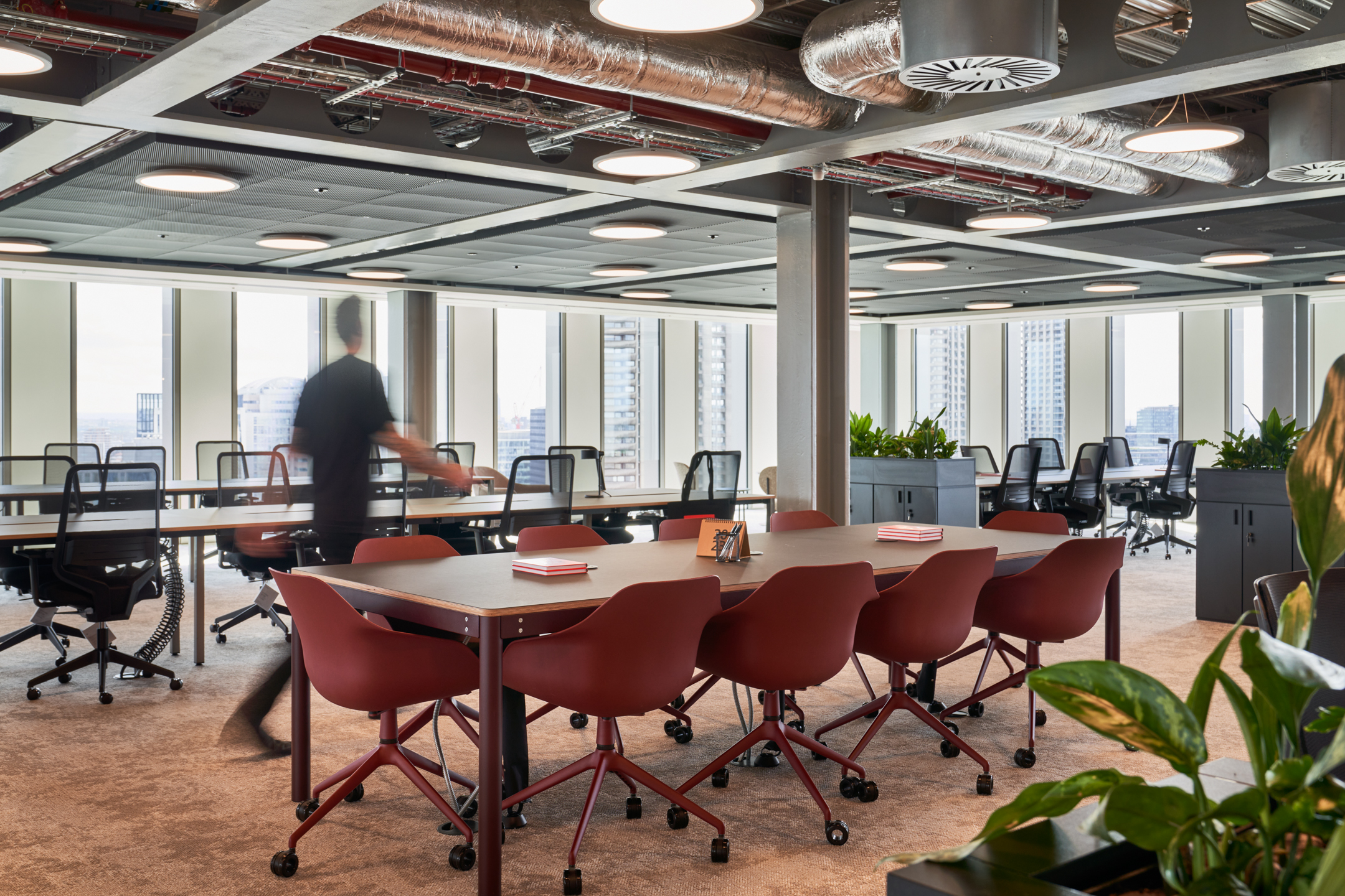 An open-plan workspace at HYLO’s Tenant-Ready™ workspace featuring long desks and task chairs. This area maximises natural light and supports flexible working arrangements.