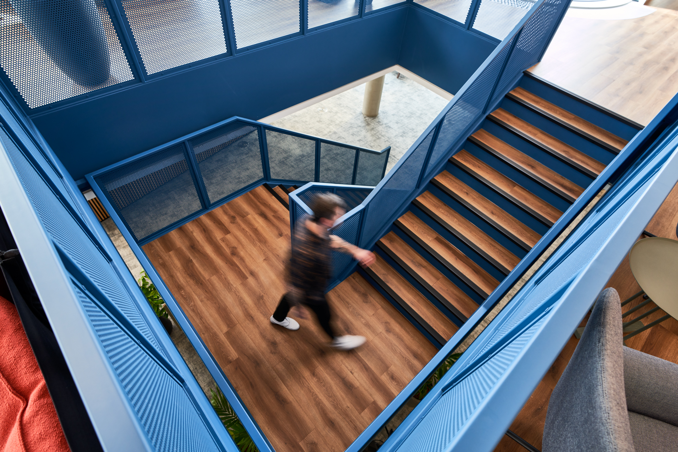 A bright blue staircase connecting different levels in Publicis Sapient’s London office, encouraging movement and interaction within the workspace.