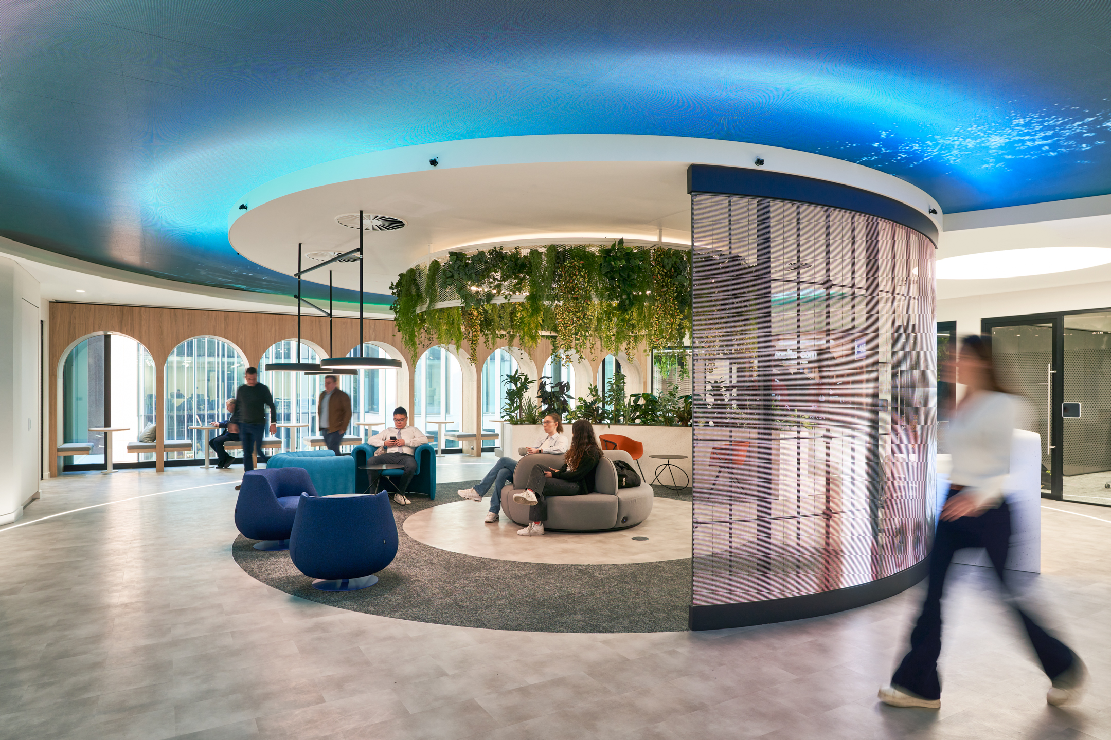 An award-winning workspace recognised at the Mixology Awards 2023, showcasing a circular seating area beneath hanging greenery, with modern design elements that encourage collaboration and creativity