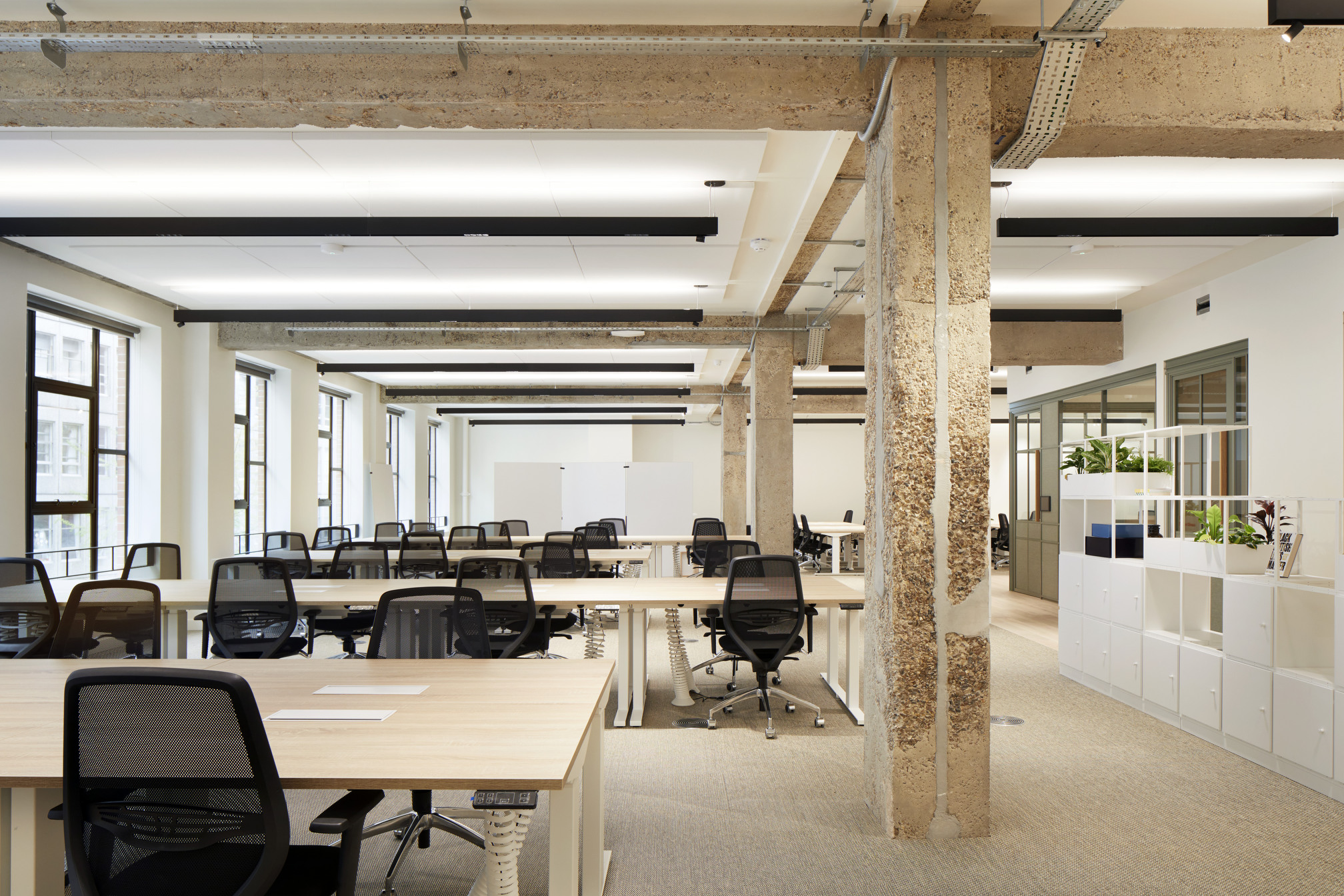 Open-plan co-working office at Fora Greencoat Place, designed by Modus, featuring exposed structural elements, natural light, and ergonomic desks, creating an efficient and comfortable workspace.