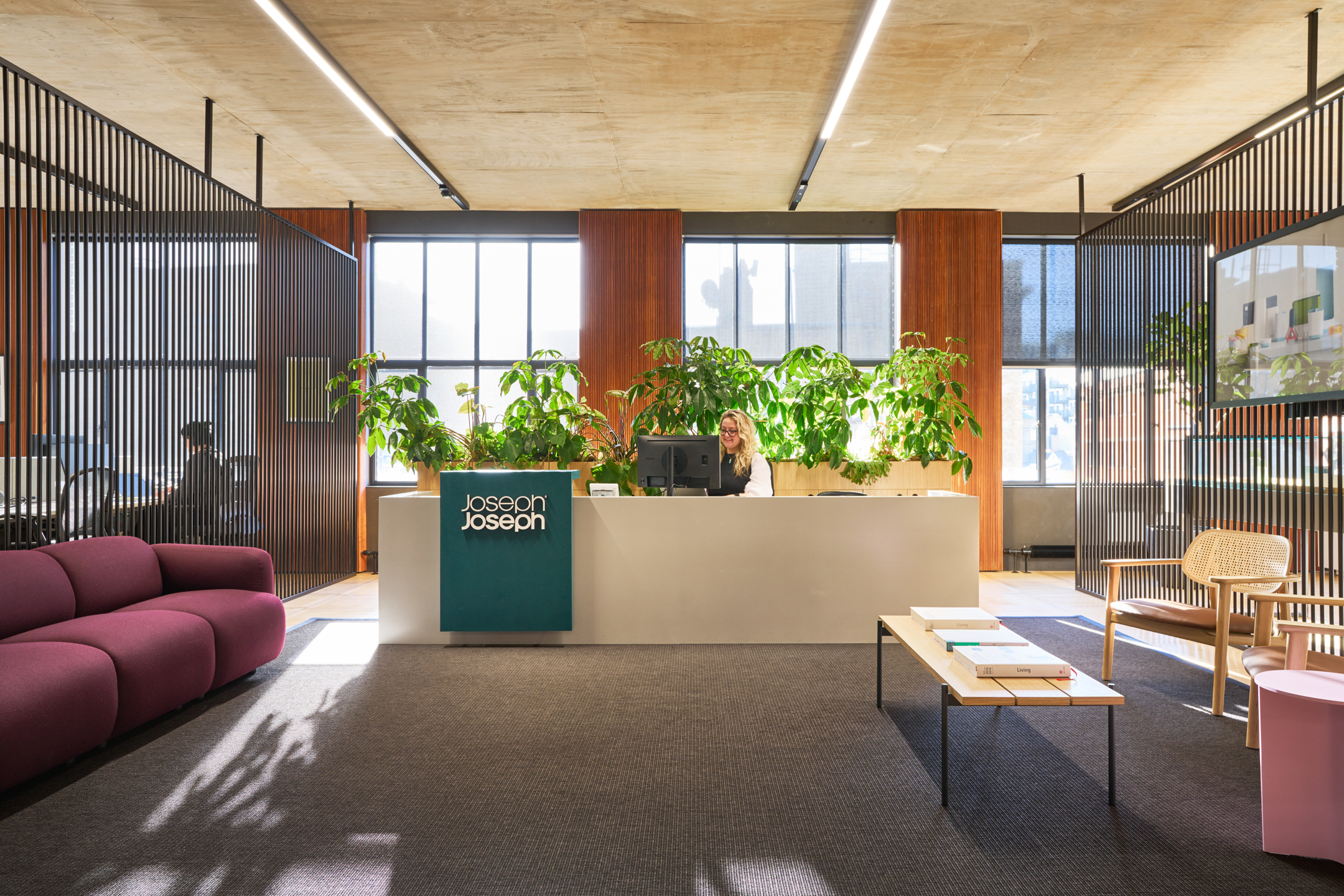 Modern reception area featuring biophilic design elements, ample natural light, and stylish furnishings to create a welcoming and professional environment for visitors and employees.