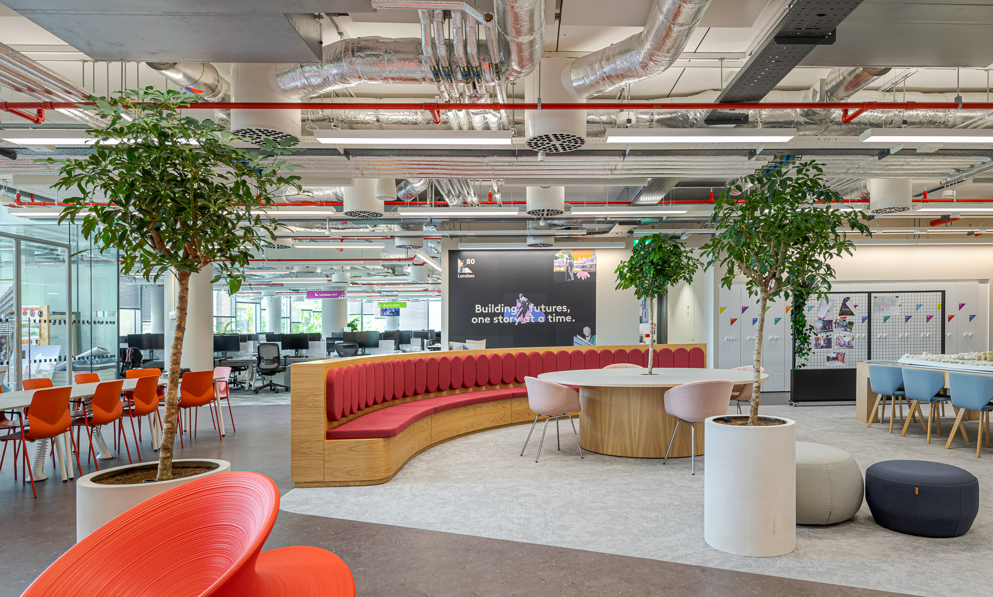 Spacious breakout area at Landsec 100 Victoria Street Headquarters, designed by Modus Workspace. The space includes colourful, ergonomic furniture, indoor plants, and a mix of casual seating arrangements to encourage collaboration