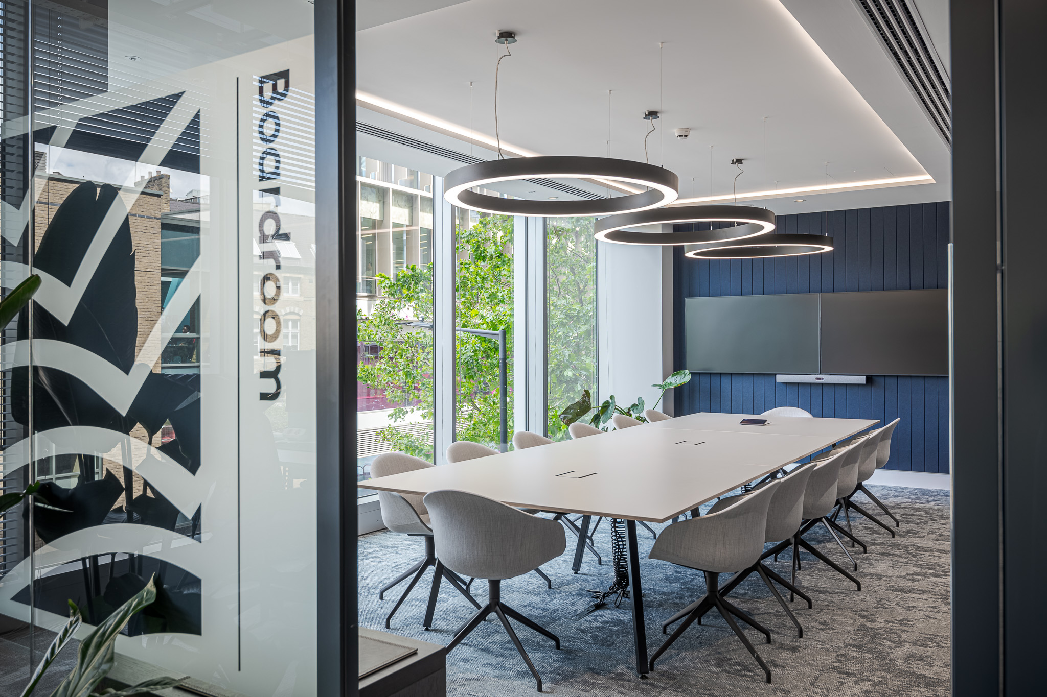 Sophisticated boardroom at Landsec 100 Victoria Street Headquarters, designed by Modus Workspace. The room features large windows, minimalist design, and state-of-the-art technology for high-level meetings