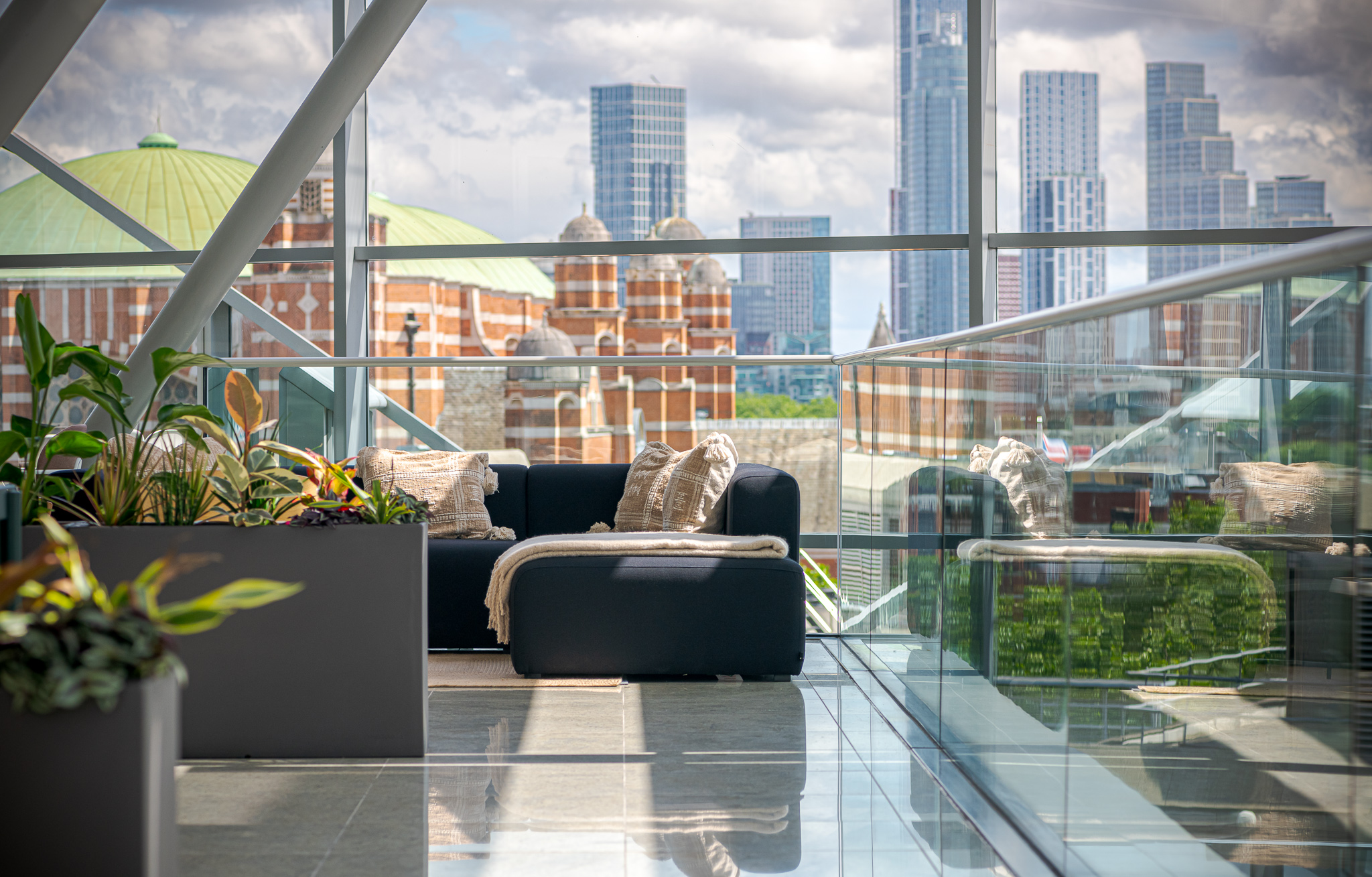 Modern open-plan workspace at Landsec 100 Victoria Street Headquarters, designed by Modus Workspace. The space features greenery, contemporary seating, and exposed ceilings, creating a vibrant and collaborative office environment.