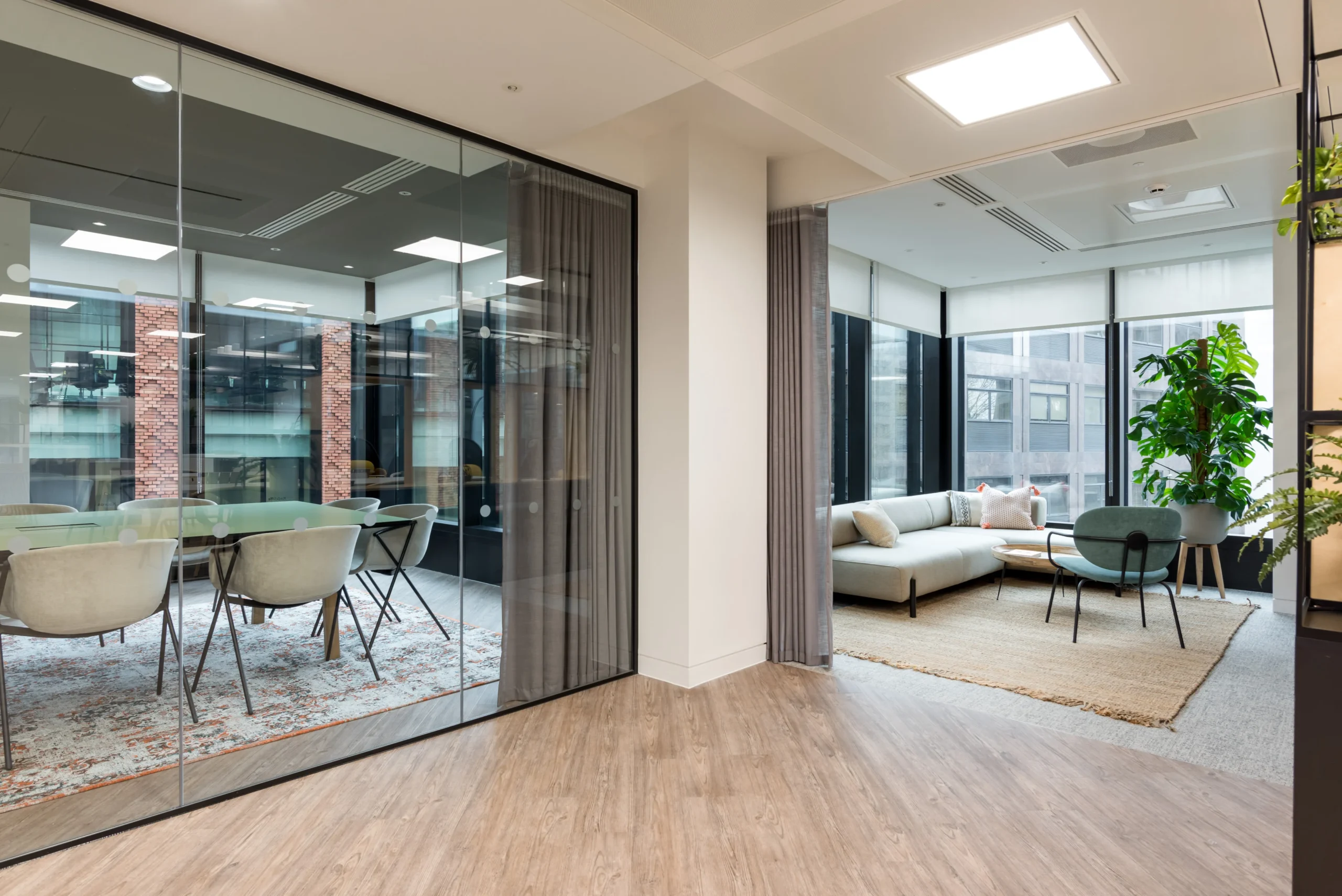 A conference room at London and Oriental, designed by Modus Workspace. The space is enclosed by glass walls and features a large, modern meeting table, ergonomic chairs, and views of the surrounding office environment.