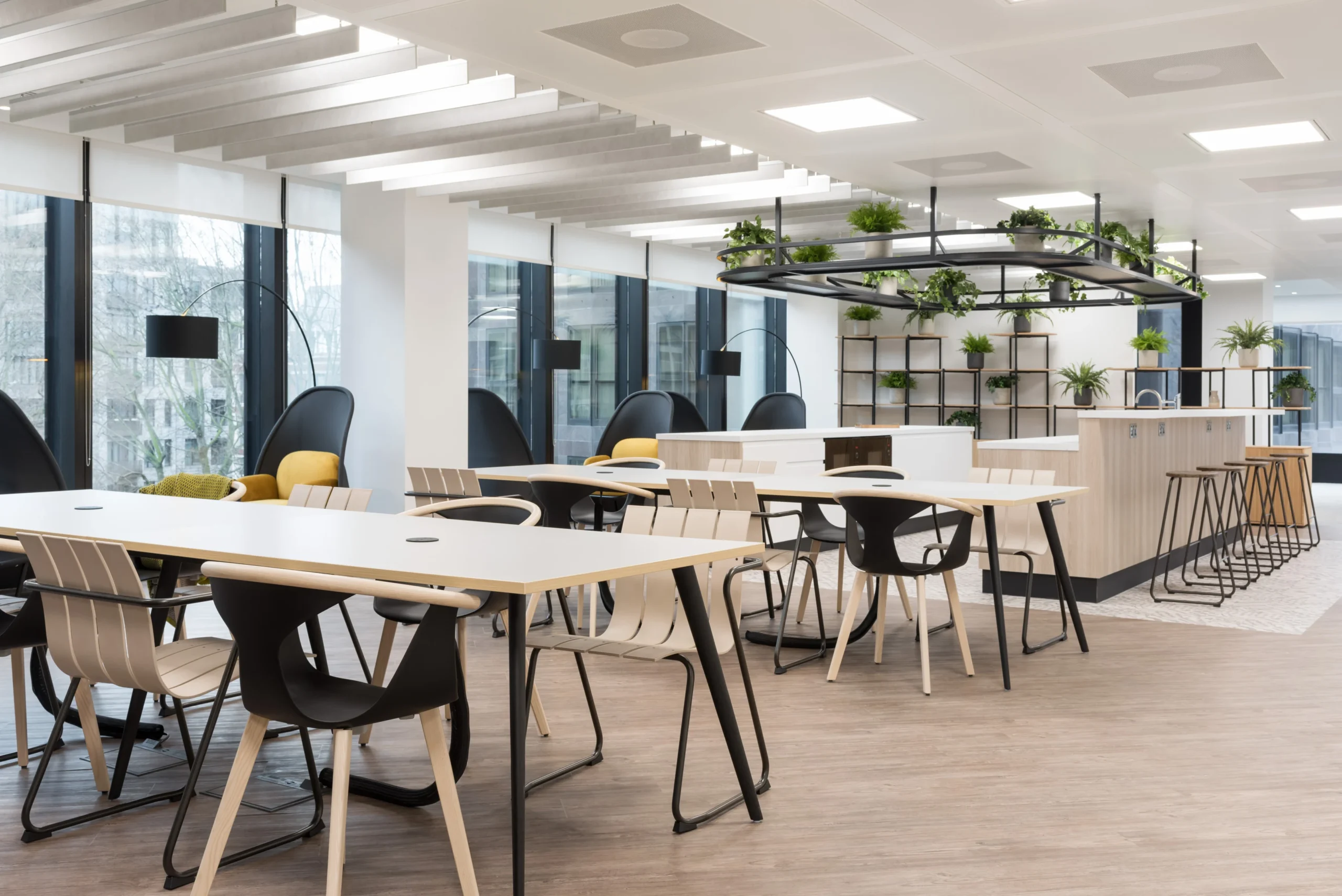 A collaborative workspace at London and Oriental, designed by Modus Workspace. The area includes several tables and chairs, along with individual seating pods, all arranged to encourage teamwork and interaction.