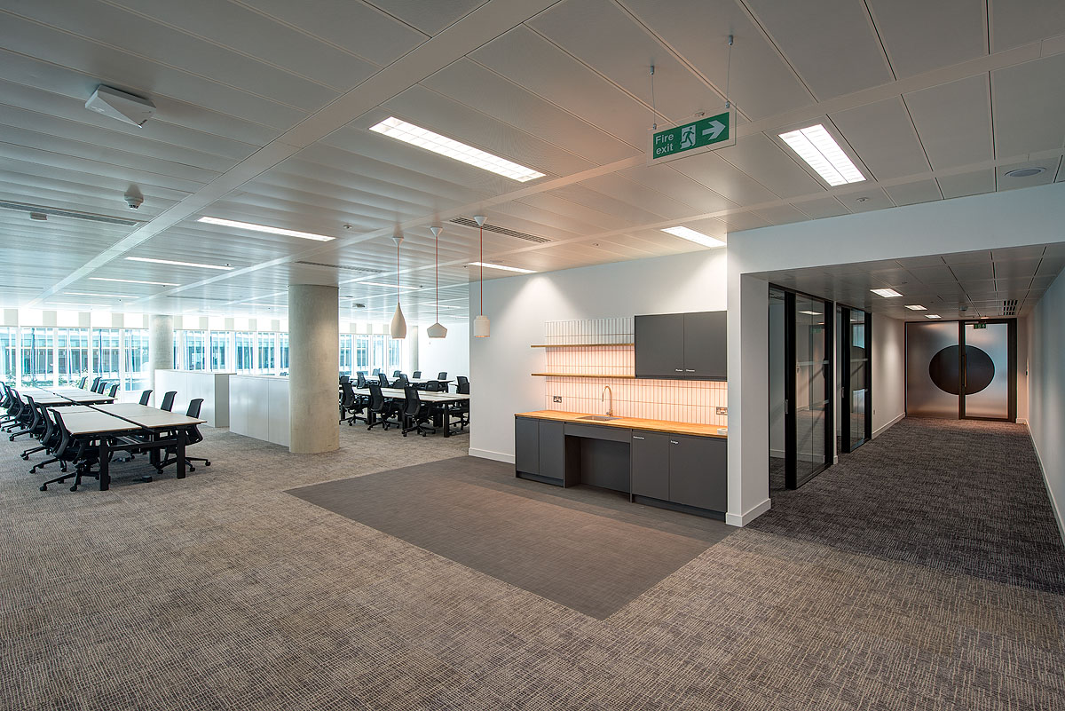 Expansive office area at Storey - 2 Kingdom Street, designed by Modus Workspace. Featuring rows of desks for collaborative work, the minimalist design emphasizes functionality with clean lines and ample natural light.