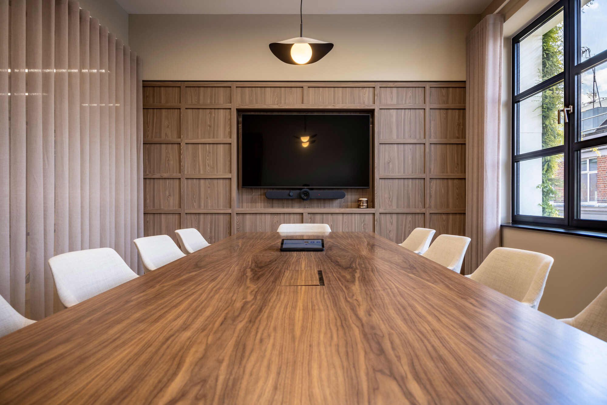 Transition designed by Two, featuring a large meeting room with a long oak table and screen.