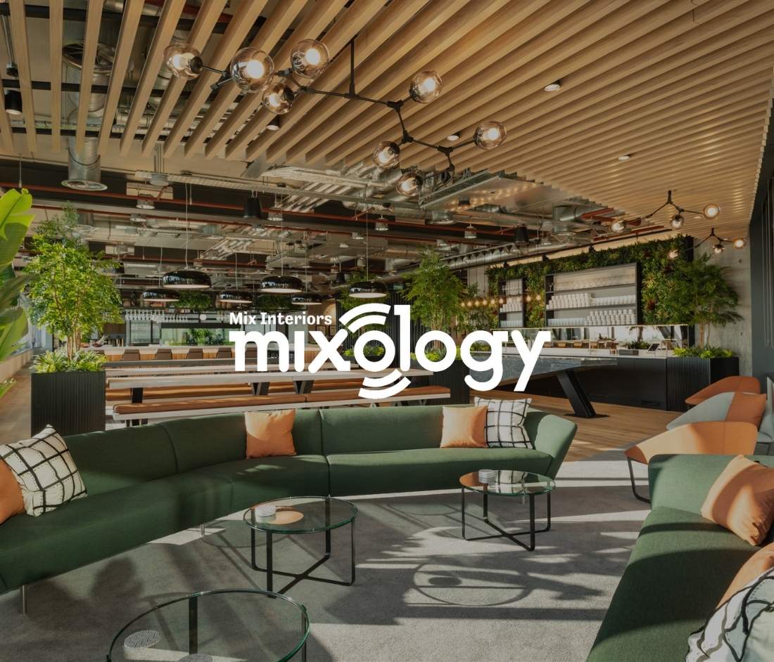 Alpha FX office space nominated for Mixology 2020 Awards, a Modus project featuring modern green lounge seating, wooden slatted ceiling, industrial lighting, and vibrant greenery integrated into the design