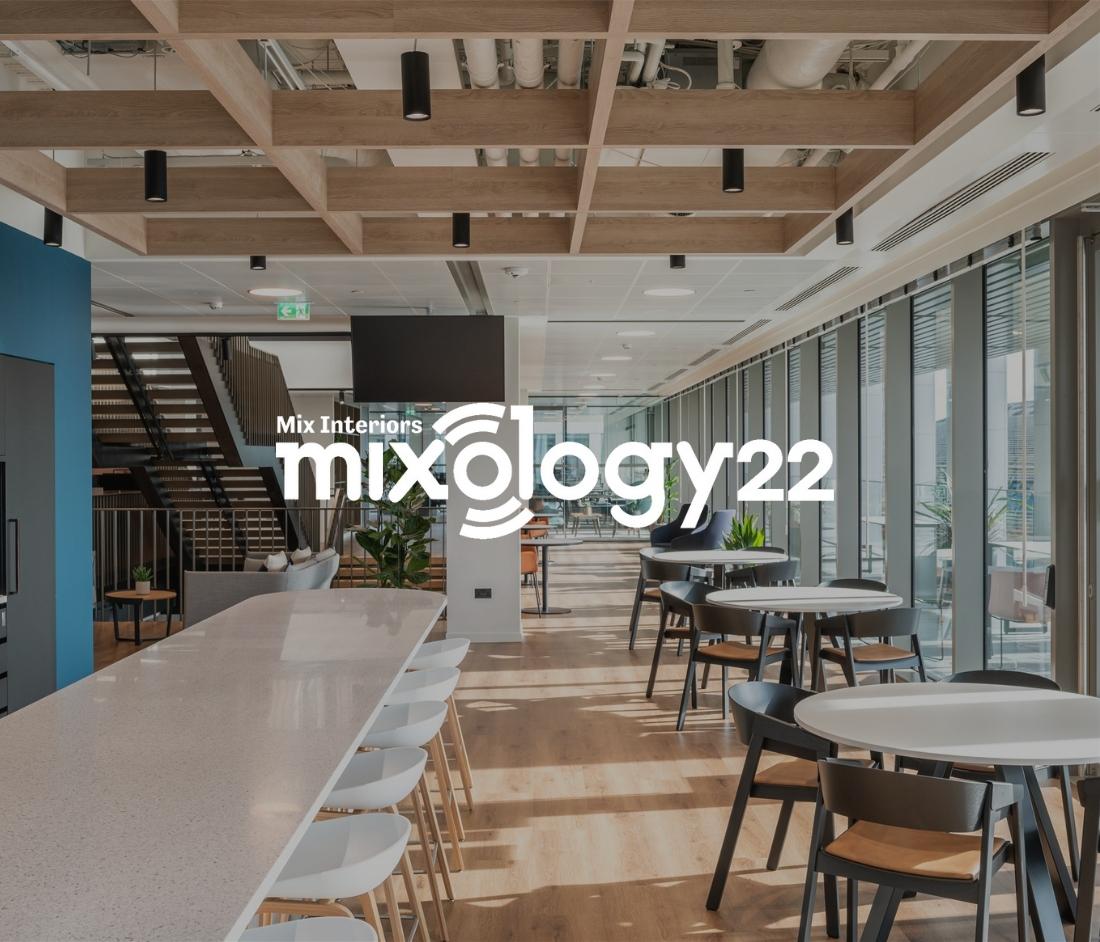 Spacious and modern office interior at Numis, finalist in the Mixology Awards 2022, featuring a long white counter, large windows, and natural light.