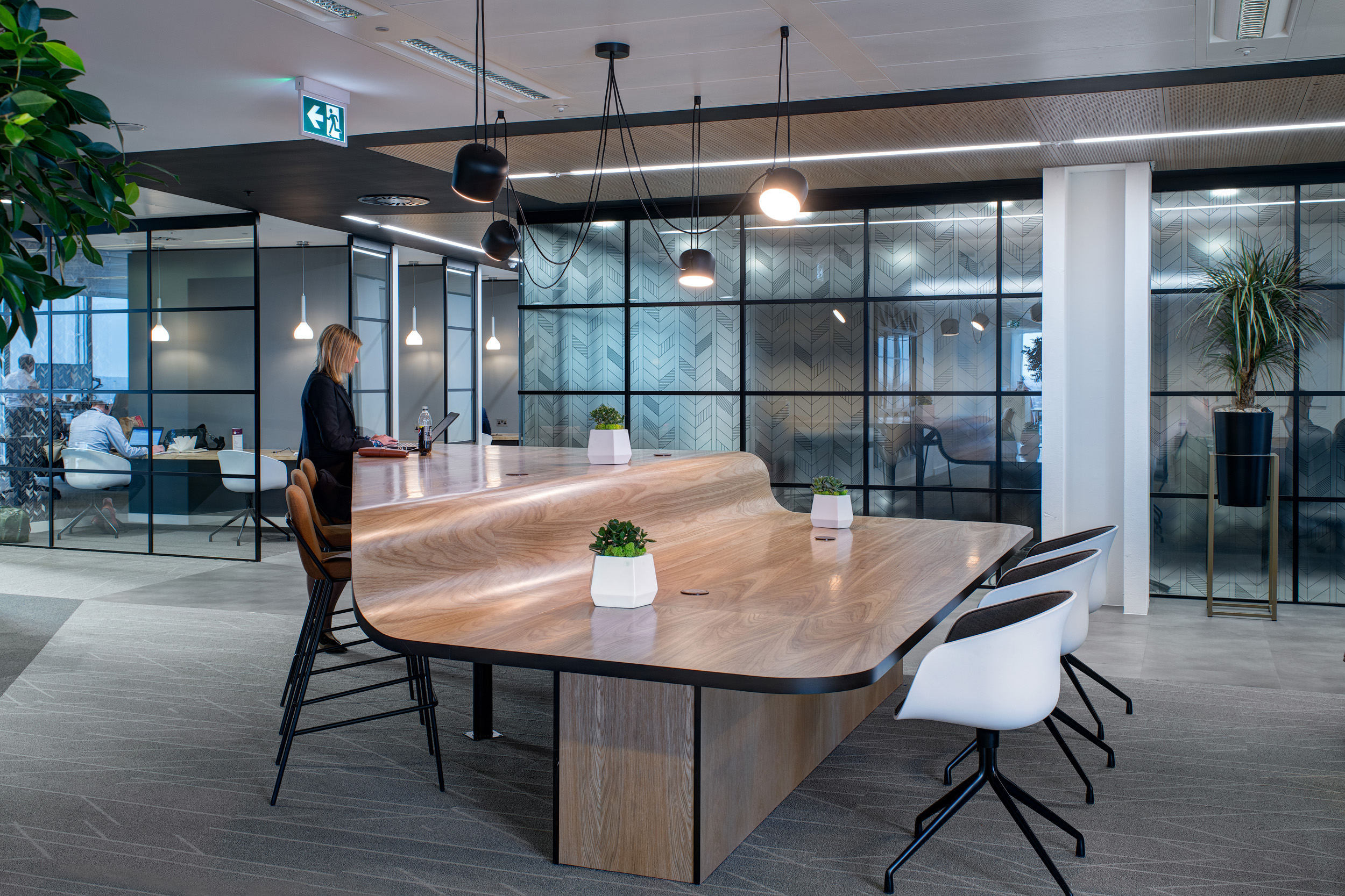 Open-plan workspace with a stepped-height desk at MITIE’s Shard office, designed to encourage flexible working and communication across teams.