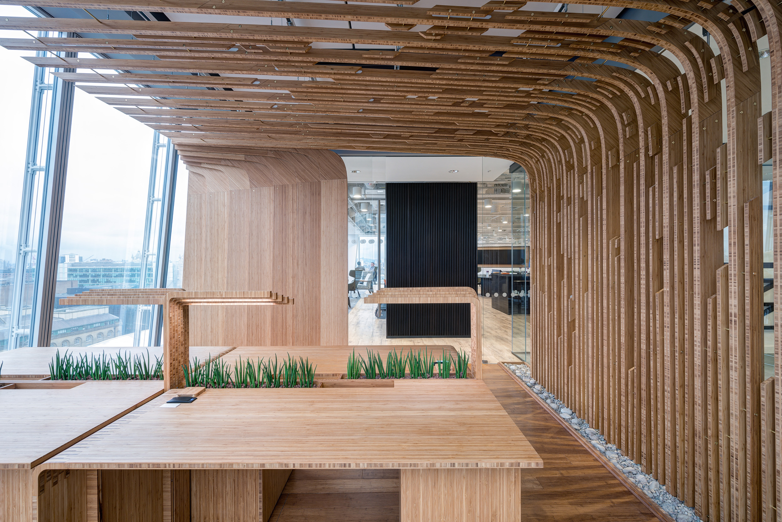 Bamboo panel installation at MITIE’s office in The Shard, serving as both a design feature and a natural partition within the workspace.