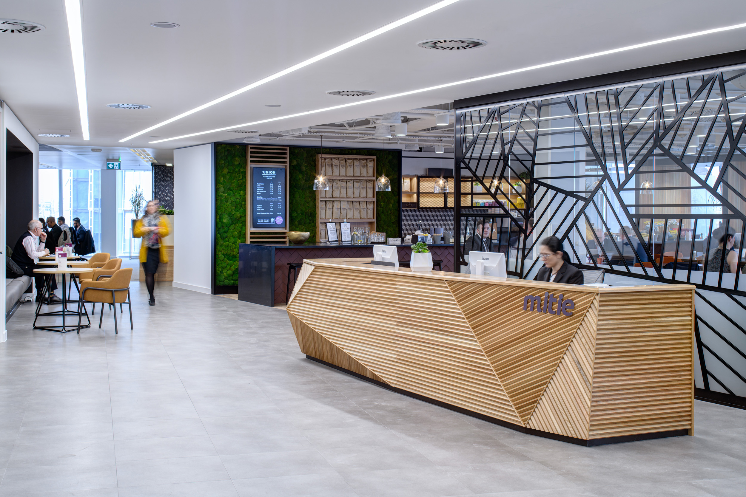 Reception area at MITIE’s office in The Shard, with a striking geometric design and biophilic elements. The design embodies MITIE’s forward-thinking and professional brand.