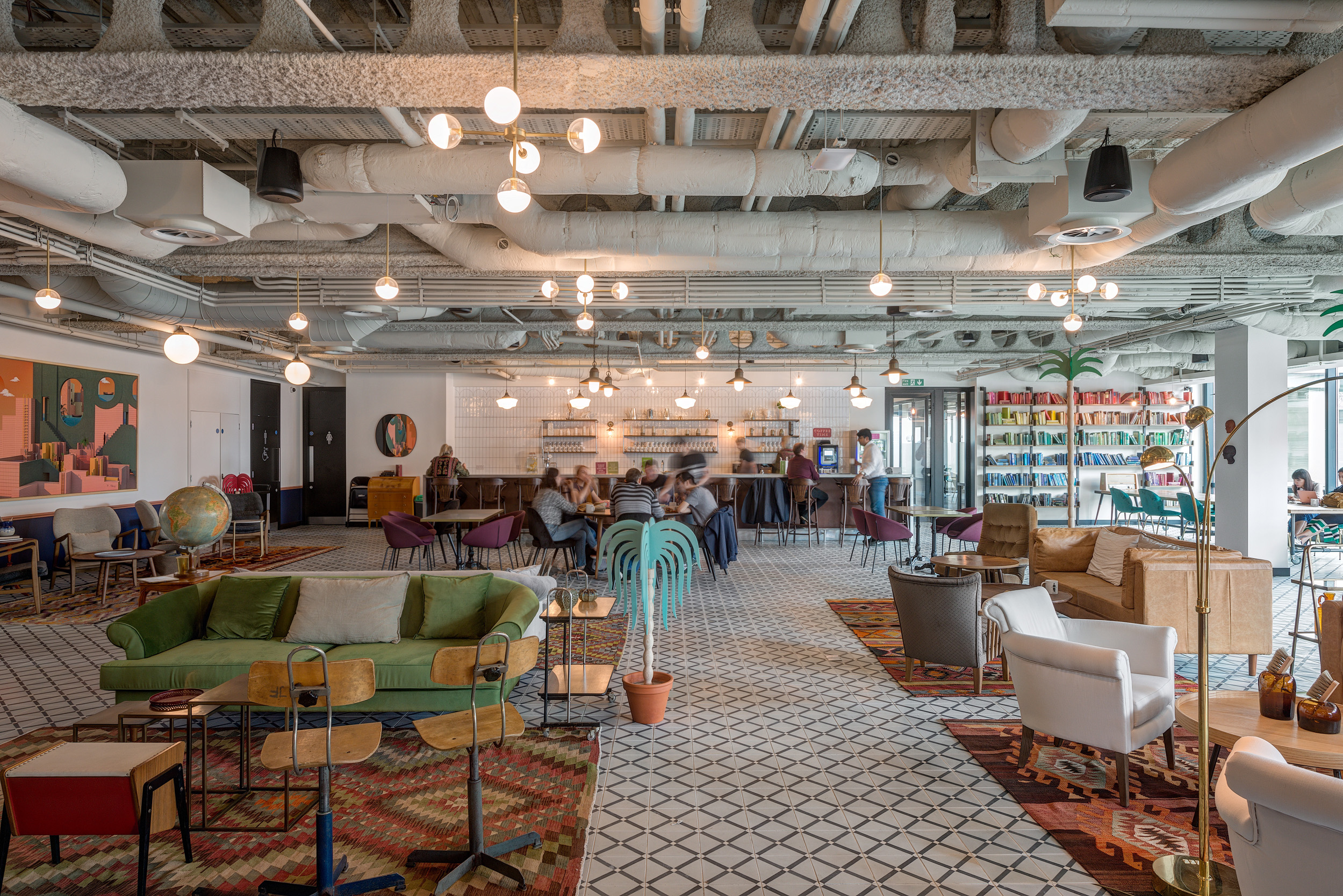 Eclectic and vibrant coworking space at Mindspace, designed by leading Design and Build firm Modus, offering a mix of comfortable seating areas and collaborative workspaces.