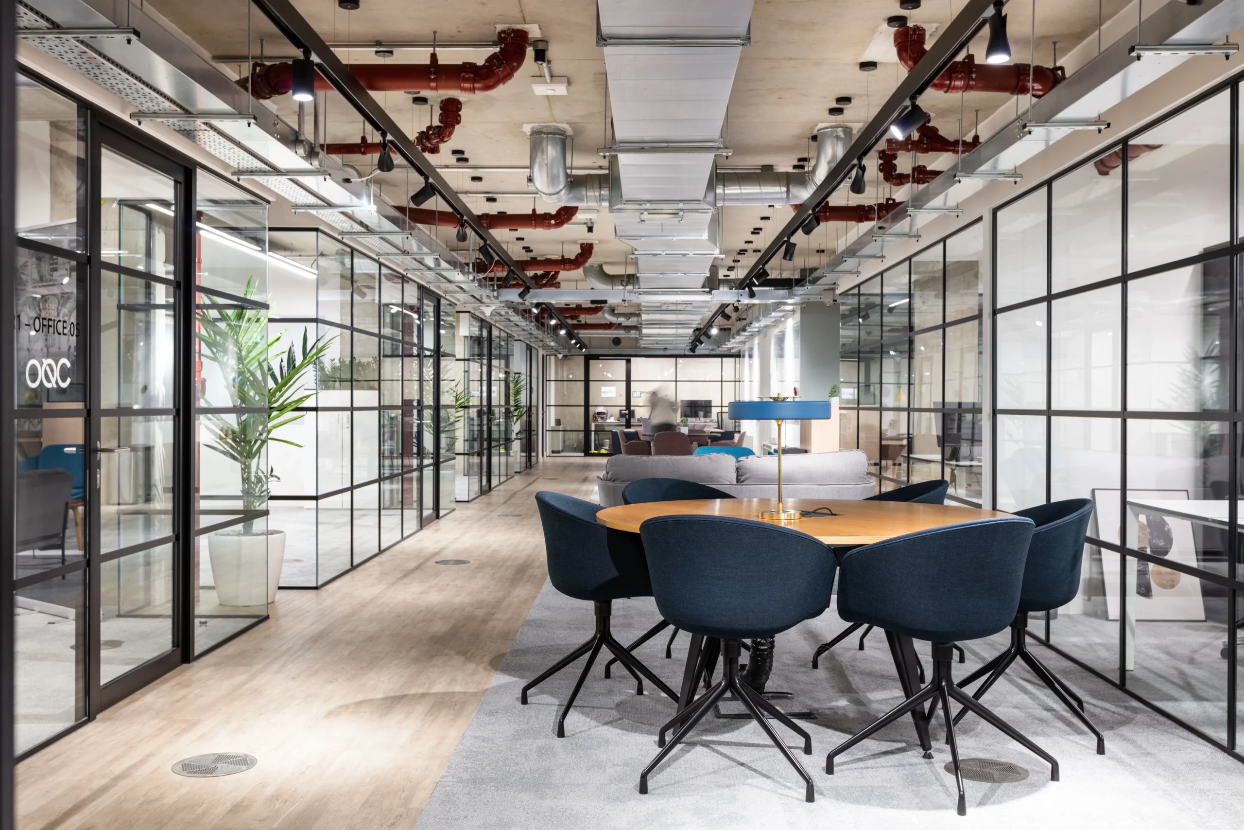 Open-plan workspace at Oxford Science Enterprises featuring private meeting rooms and communal areas to support collaboration and productivity.