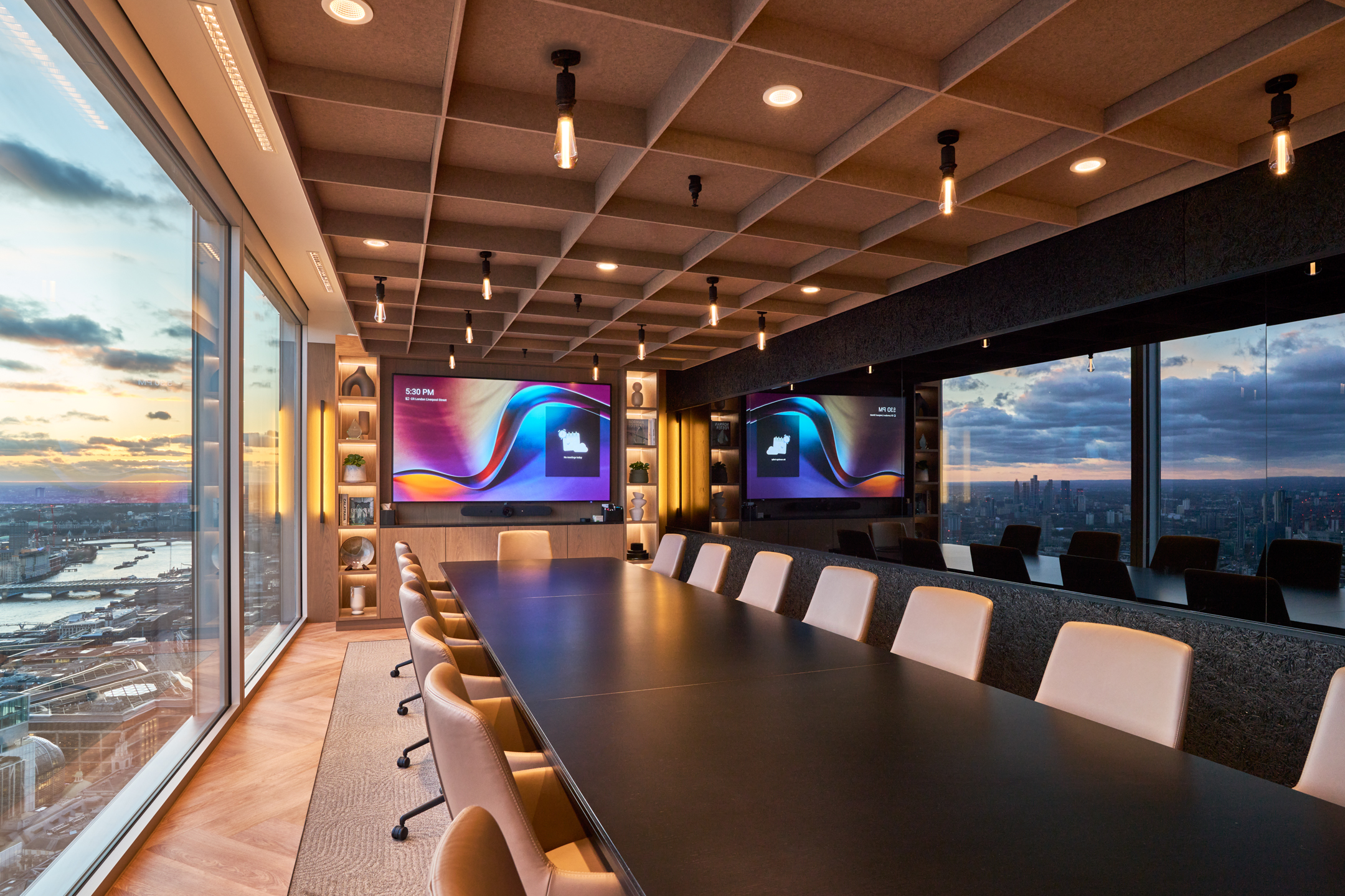 A high-end office boardroom featuring modern technology and floor-to-ceiling windows, reflecting Toby Benzecry’s research on office design impact.