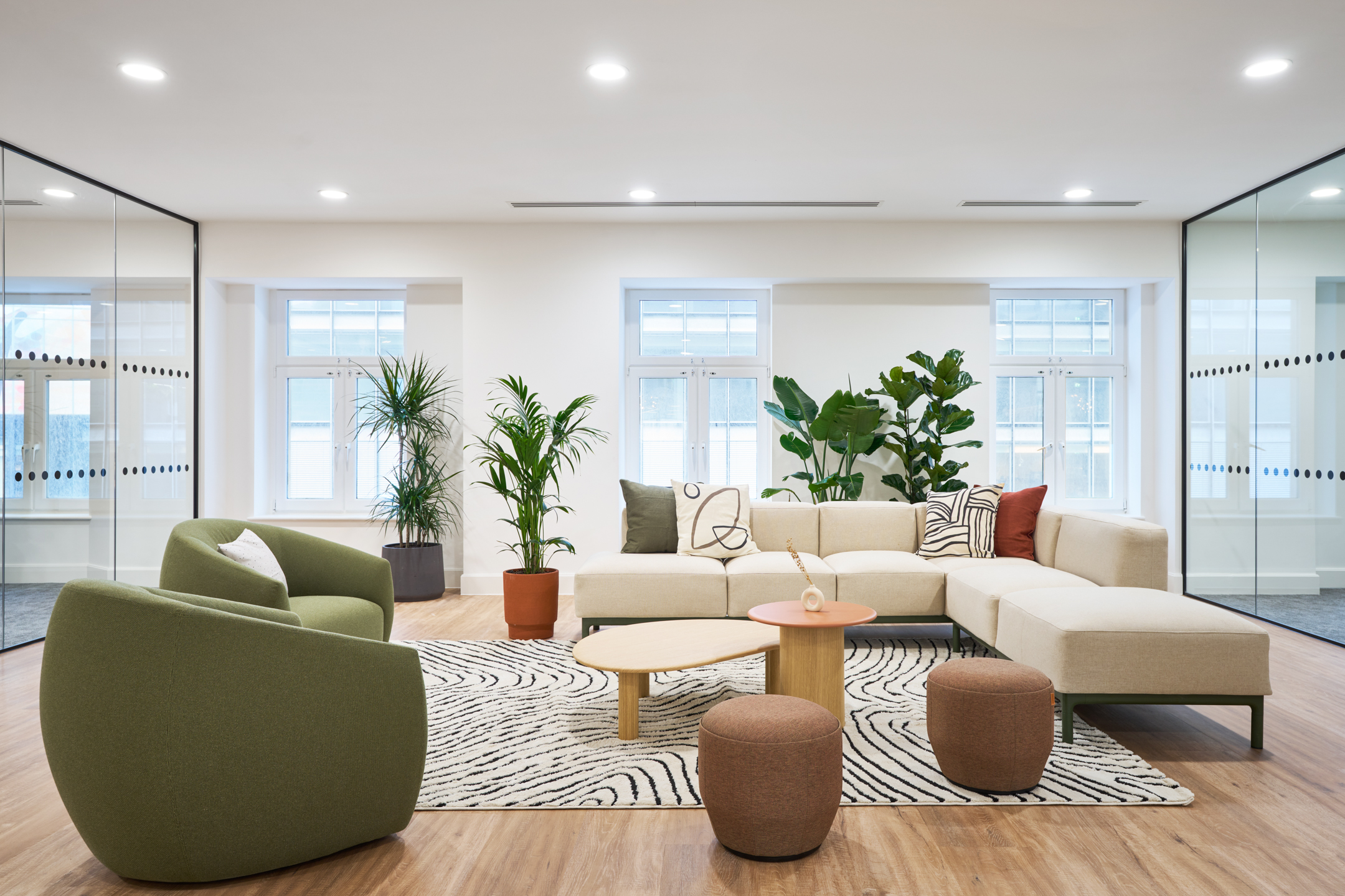 Cozy and Stylish Seating Area with Biophilic Plants, Pillows and Cream Sofas