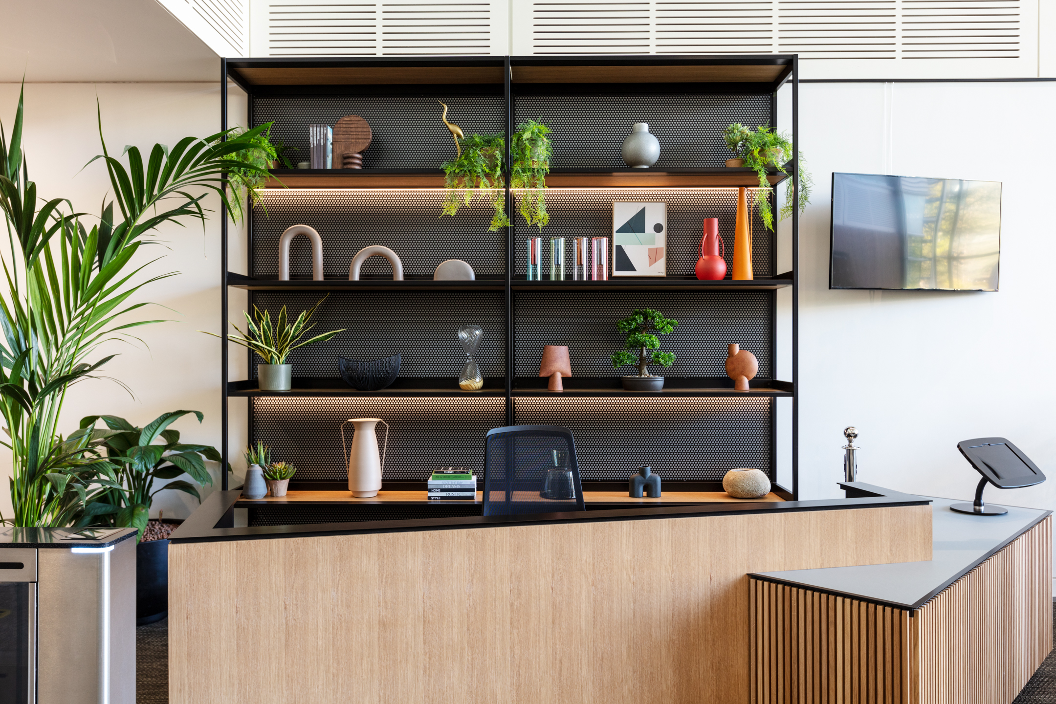 Bookshelf displaying biophilic designs and textiles at Chiswick Business Park, Building 9