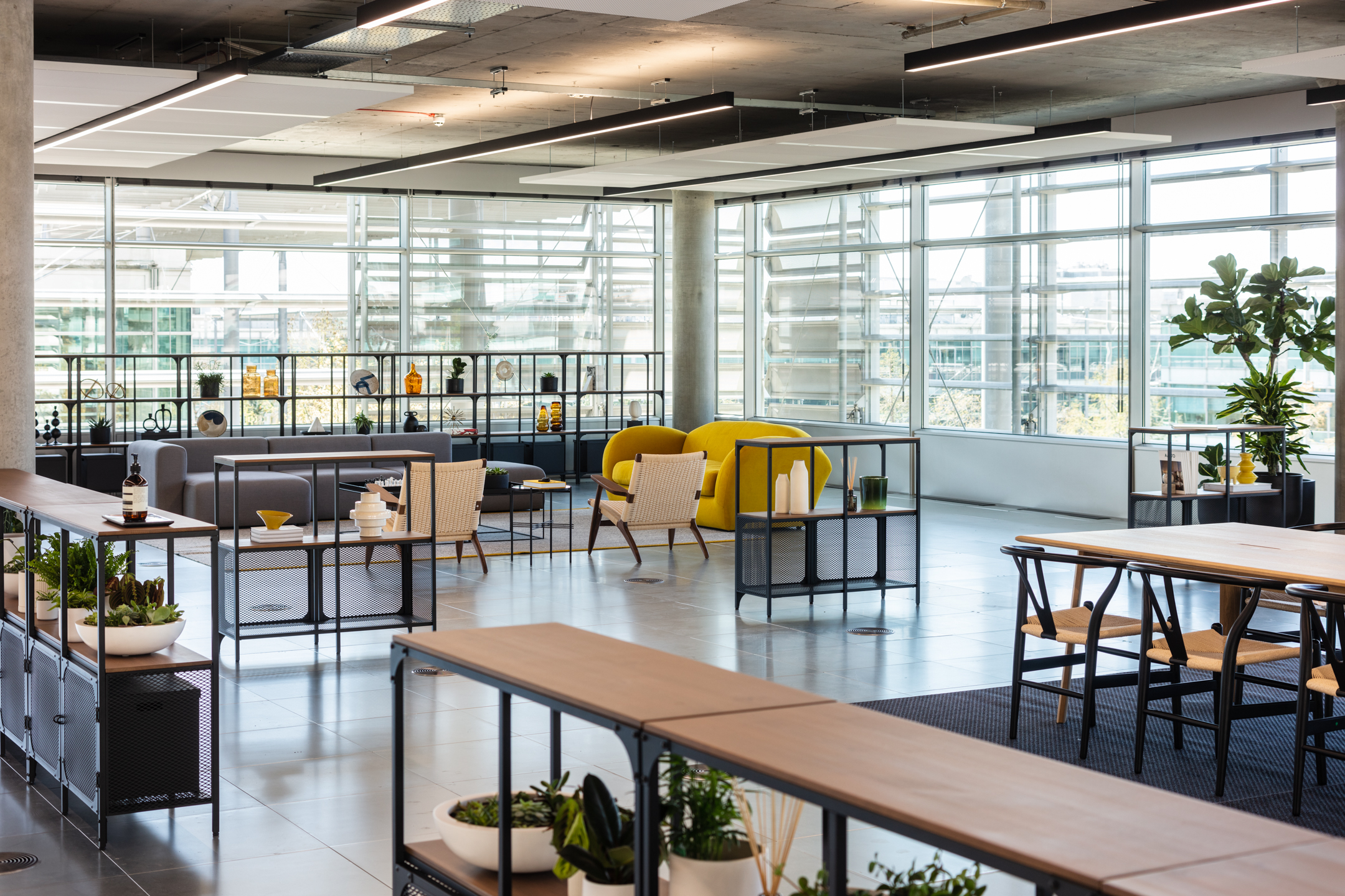 Open Plan Workspace with yellow accents and floor to ceiling windows