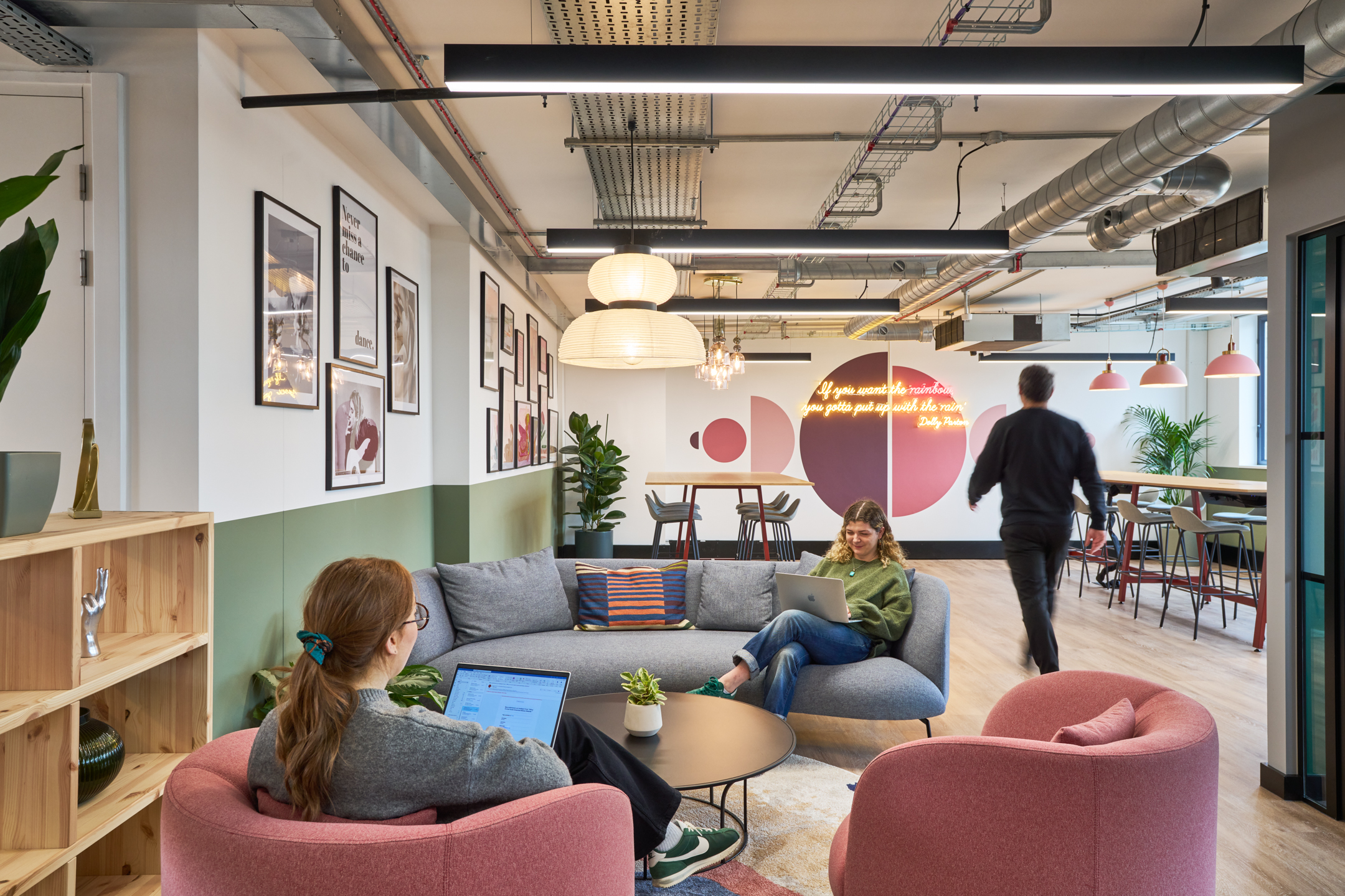 The lounge area at Work.Life's Waverly House, showcasing cosy seating, modern decor, wall art, and a neon sign, fostering a relaxed and collaborative atmosphere.