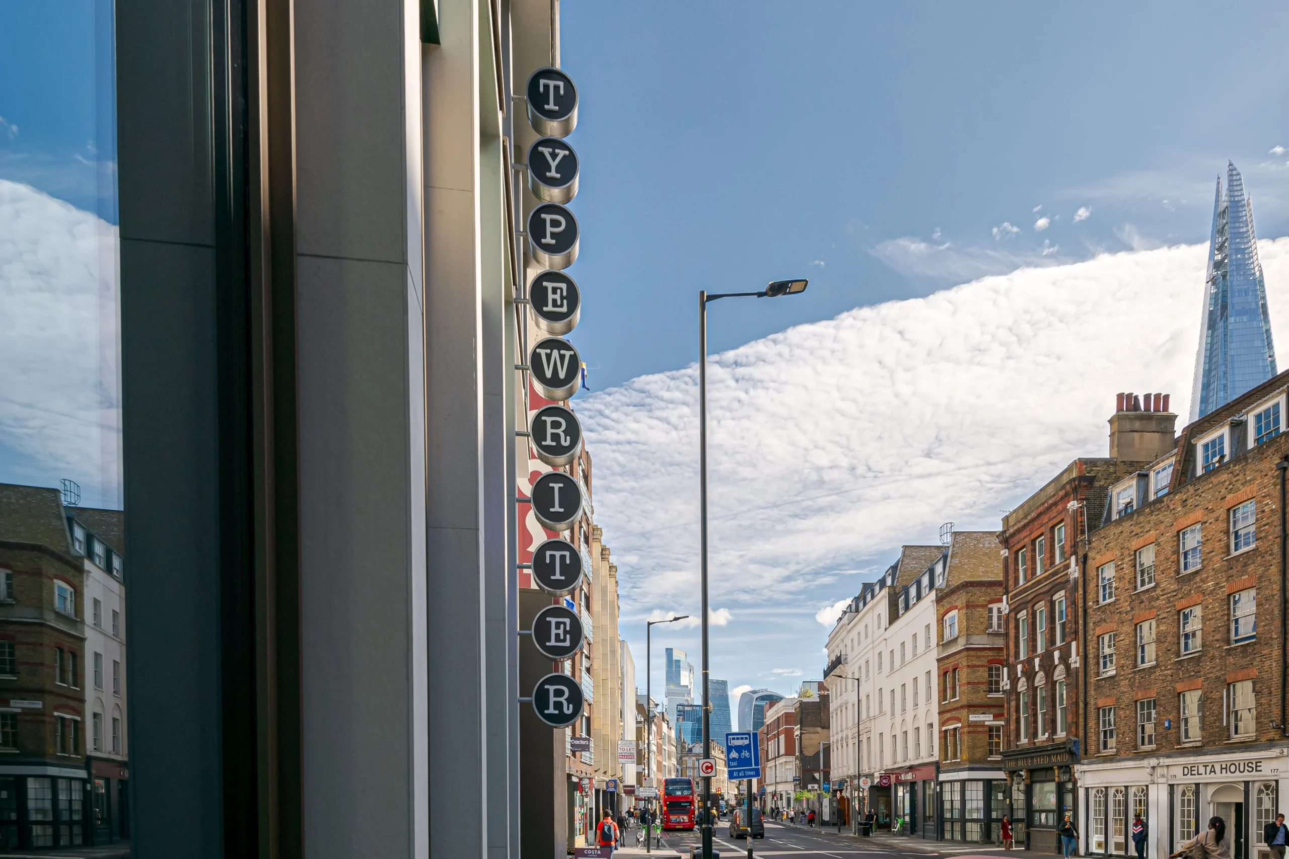 The exterior of Work.Life’s Typewriter Building in London, featuring the iconic typewriter key signage with the Shard visible in the background.