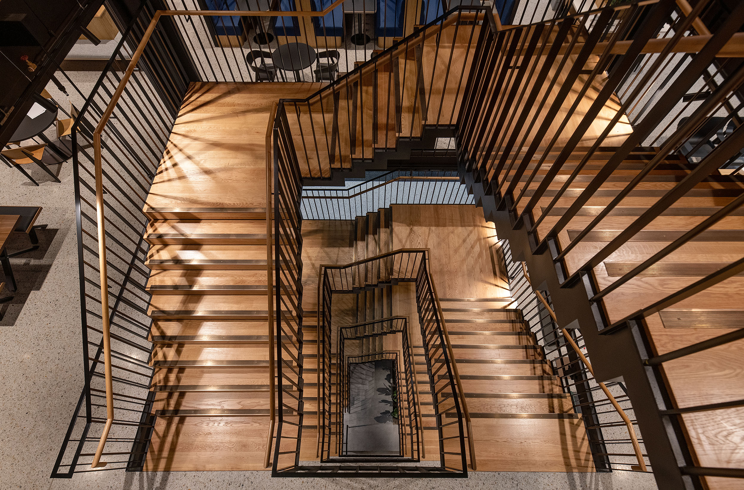 Feature staircase connecting floors to promote movement and team interaction in a tech office