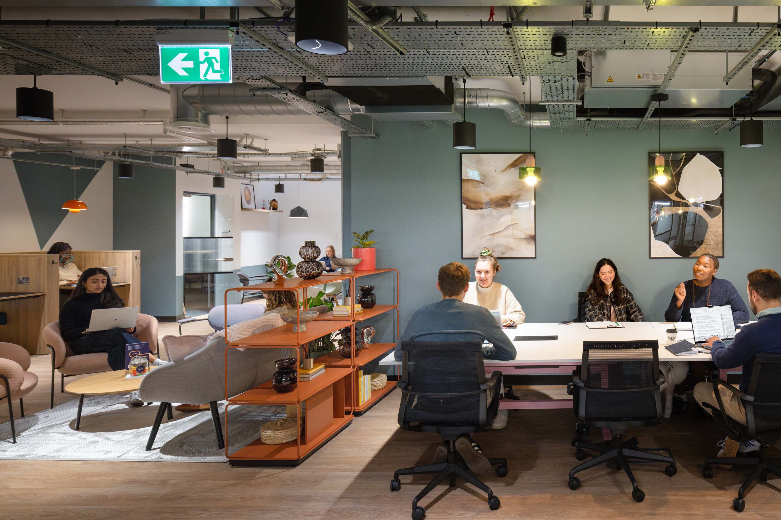 Open coworking space with communal desks, natural lighting, and a modern, flexible layout for dynamic workstyles