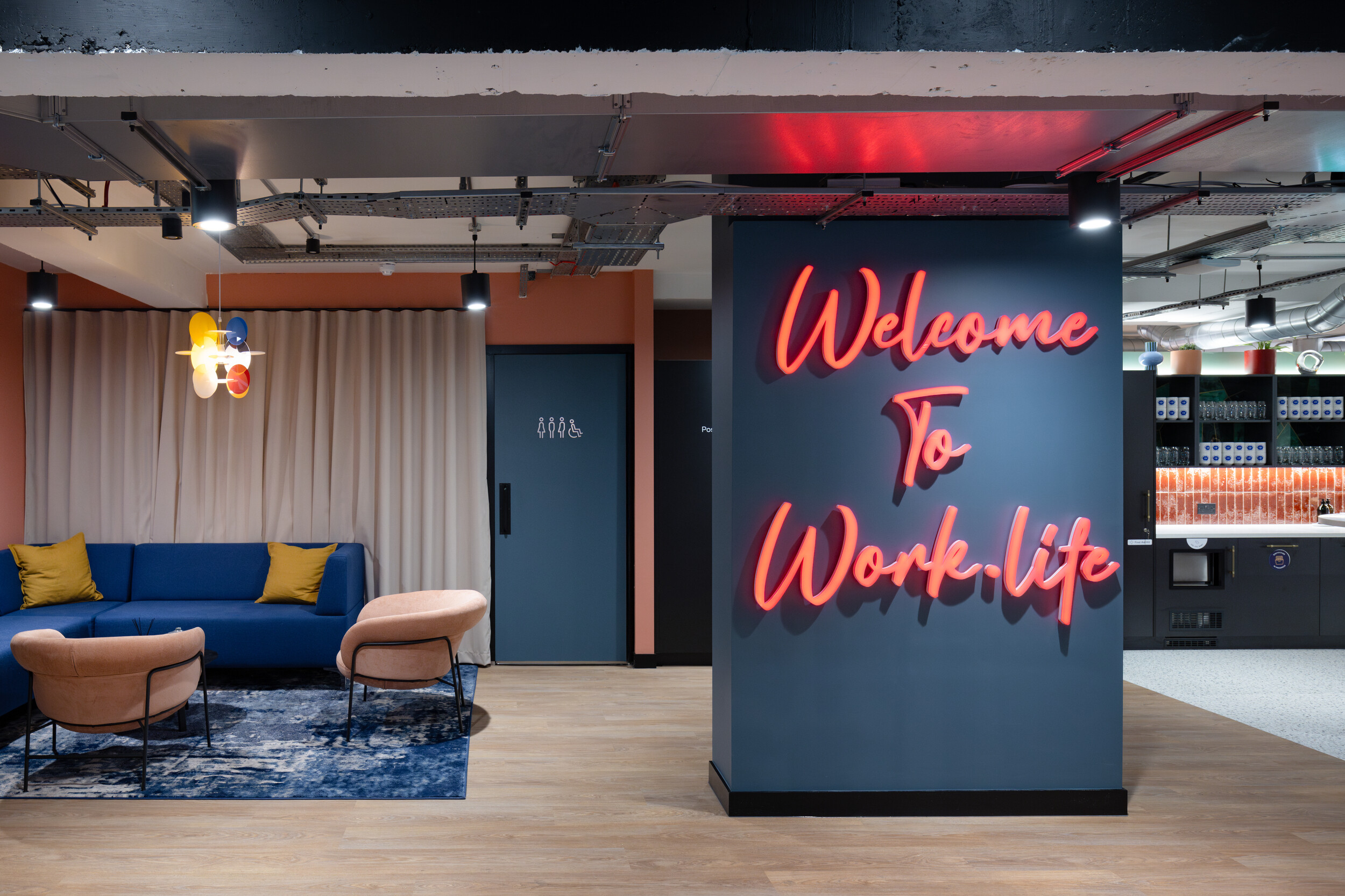 Work.Life branded entrance with illuminated welcome sign, creating a vibrant first impression for visitors