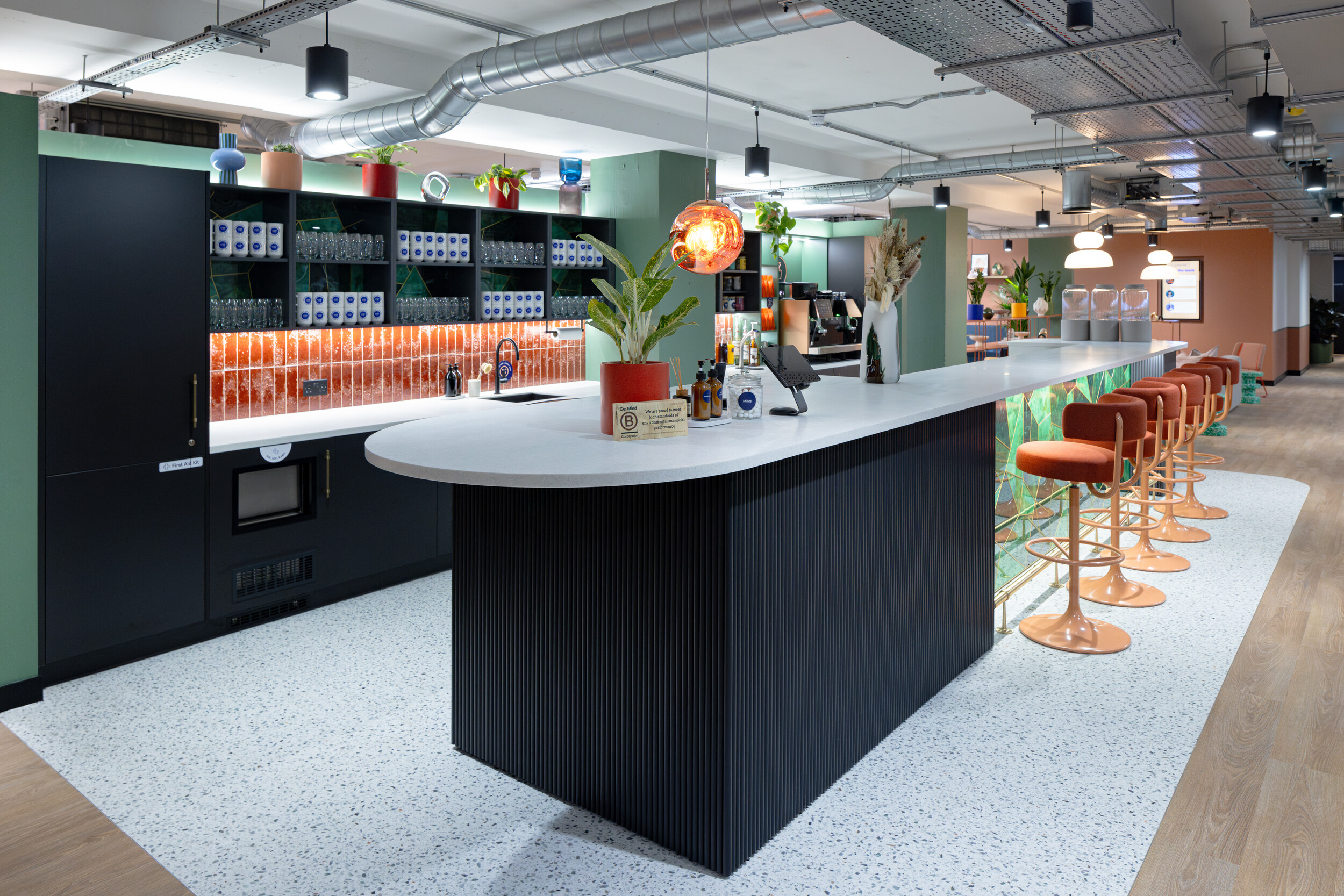 Central kitchen island with striking gemstone-inspired countertop, serving as a visual anchor in the shared workspace