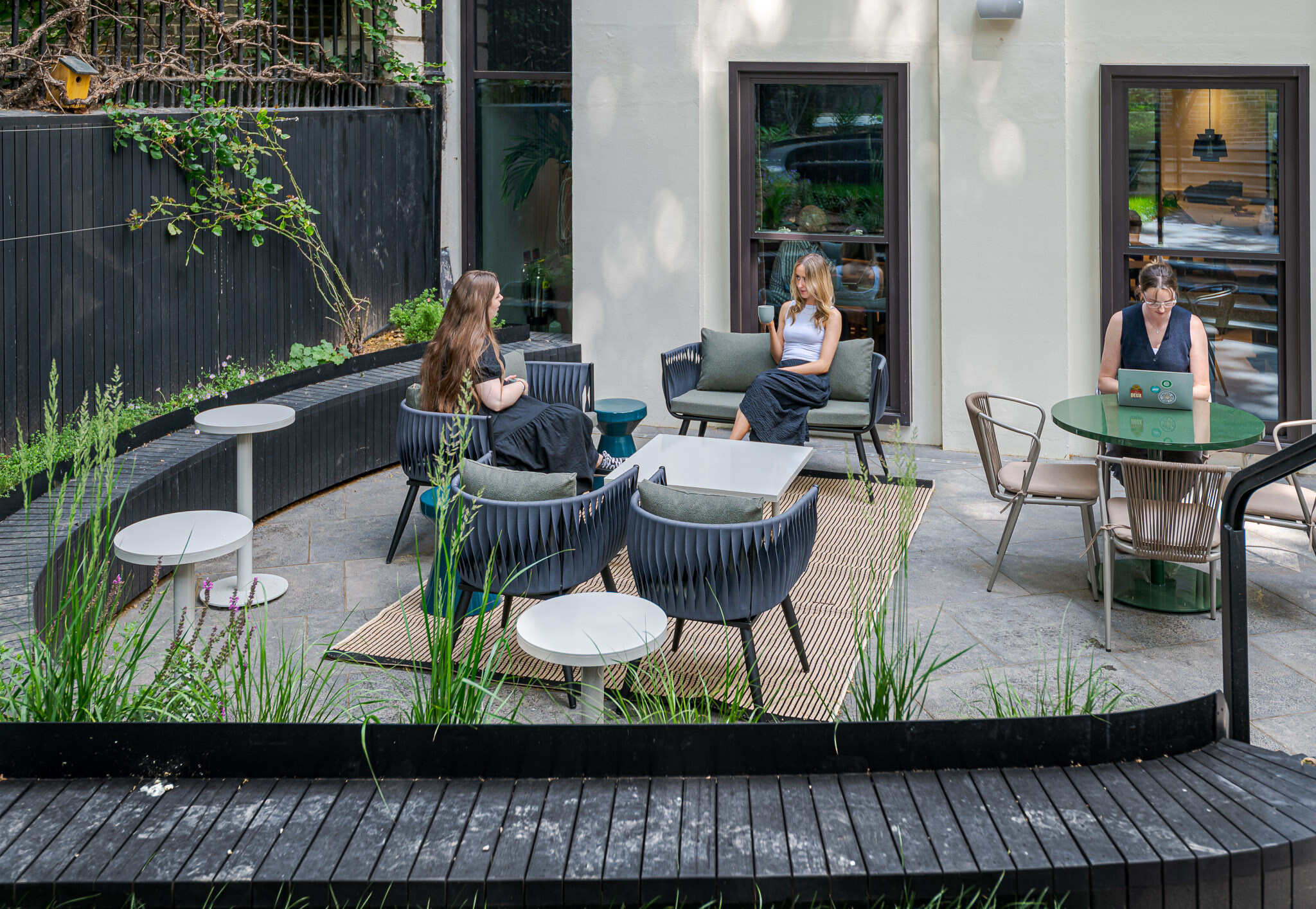 Lush courtyard at Bloomsbury House with modern outdoor seating and flexible working areas.