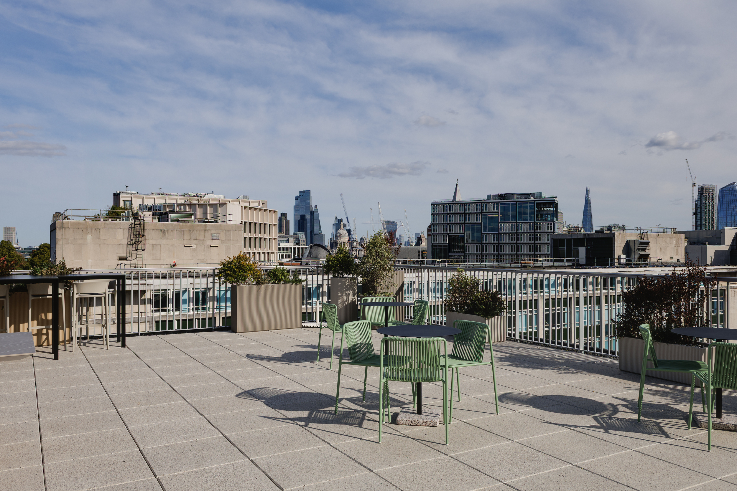Rooftop terrace at Space House Clubhouse furnished by Platfform with green outdoor seating and planters, designed by Modus to create a social destination overlooking London’s skyline.