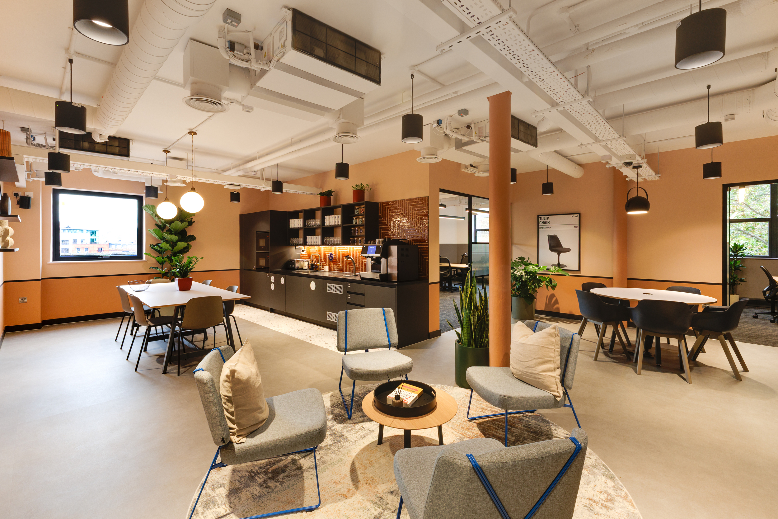 Open-plan teapoint and lounge at Work.Life Clerkenwell Green with terracotta walls, soft seating and modern lighting, expressing the collaborative workspace identity shaped through Two and Platfform.