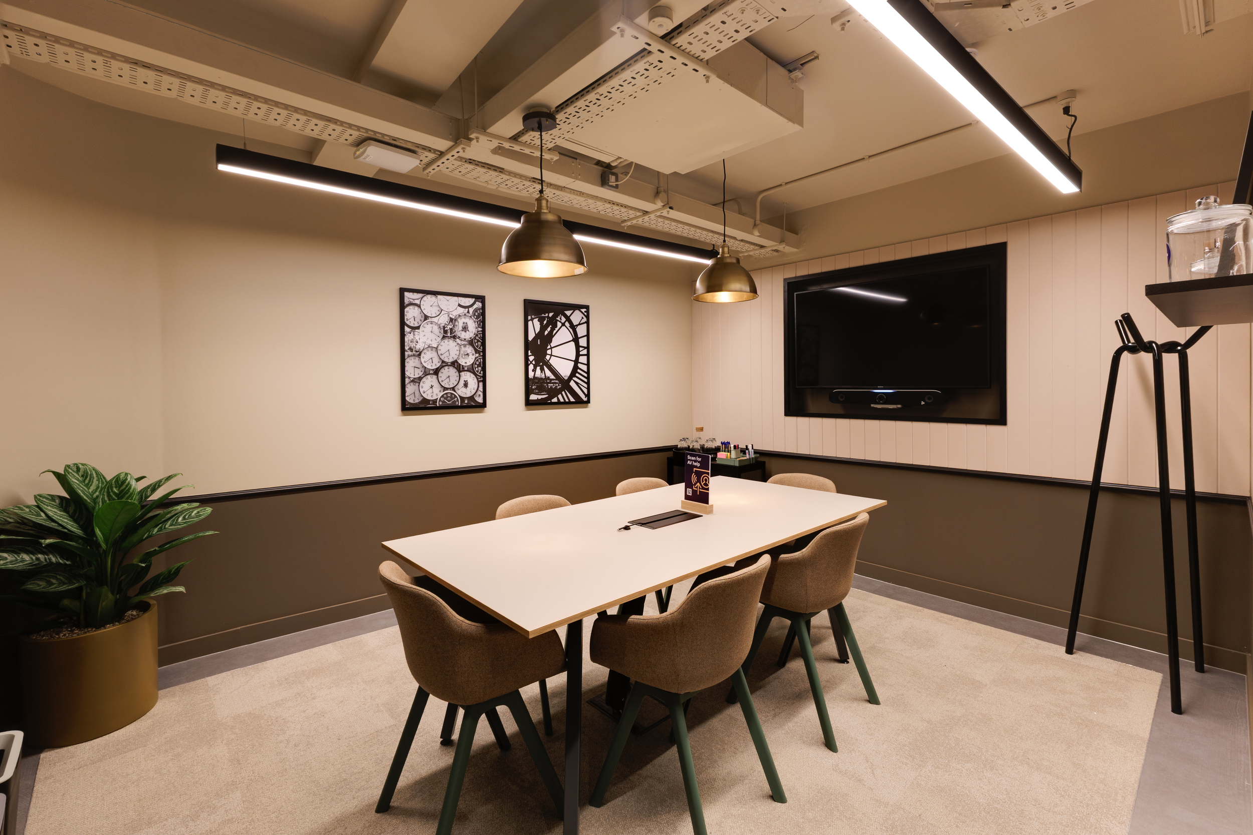 Lower ground meeting room at Work.Life Clerkenwell Green featuring green acoustic walls, matching curtains and warm lighting, furnished through Two and Platfform’s workspace collaboration.